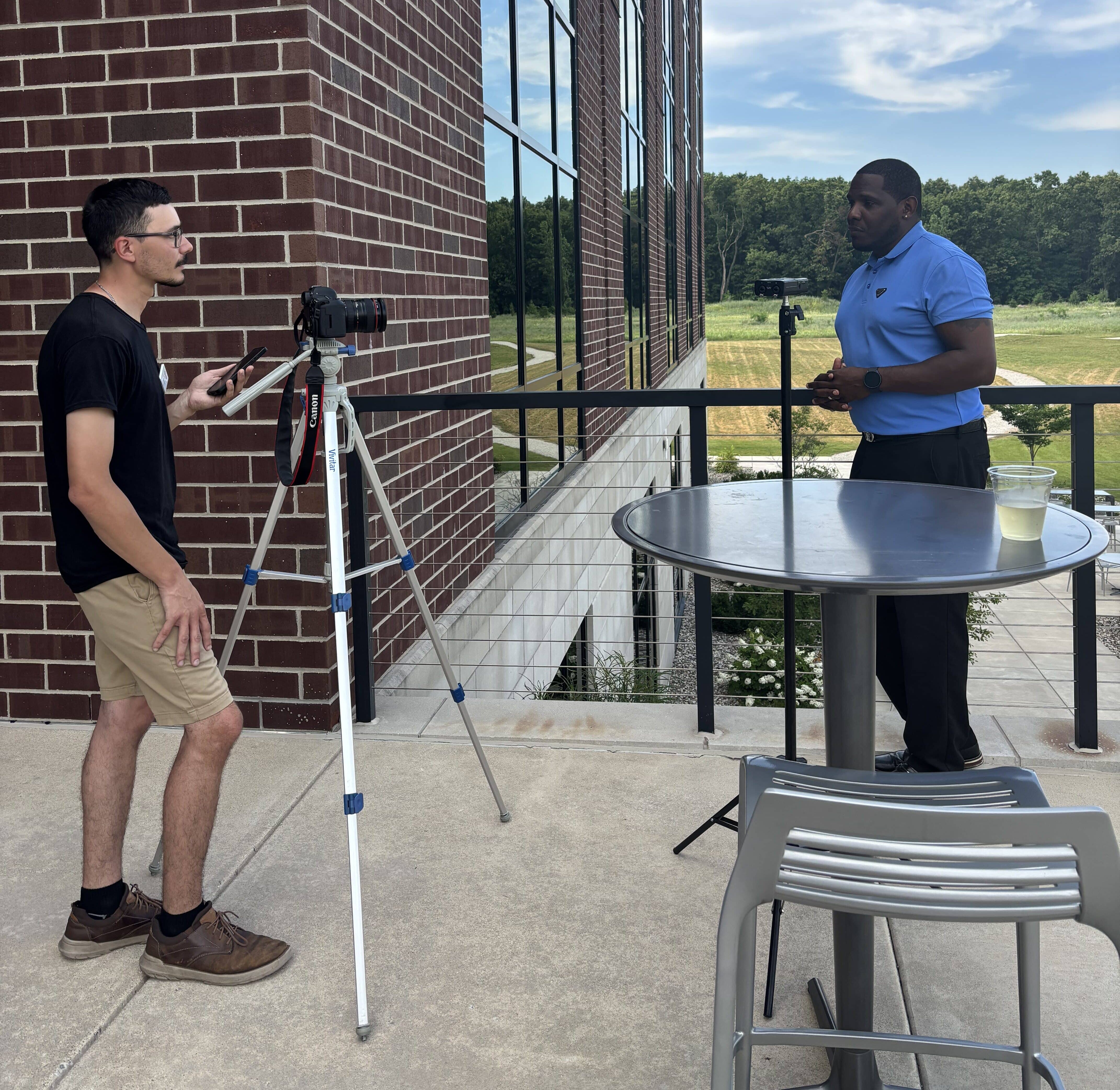 Team member, Alex, taking professional photo at Kalamazoo chamber event