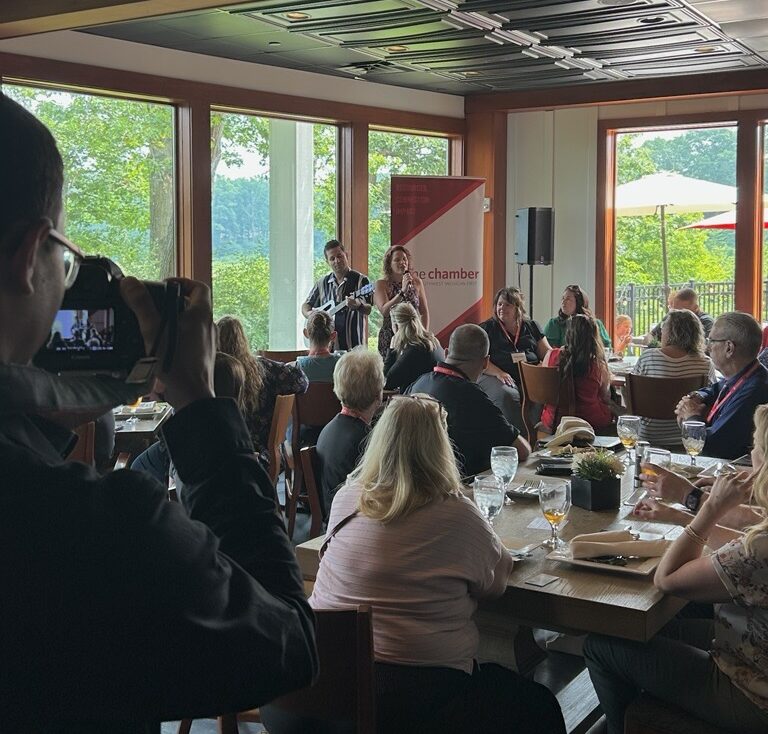 Team member, Alex, taking pictures of Kalamazoo professionals at local networking event